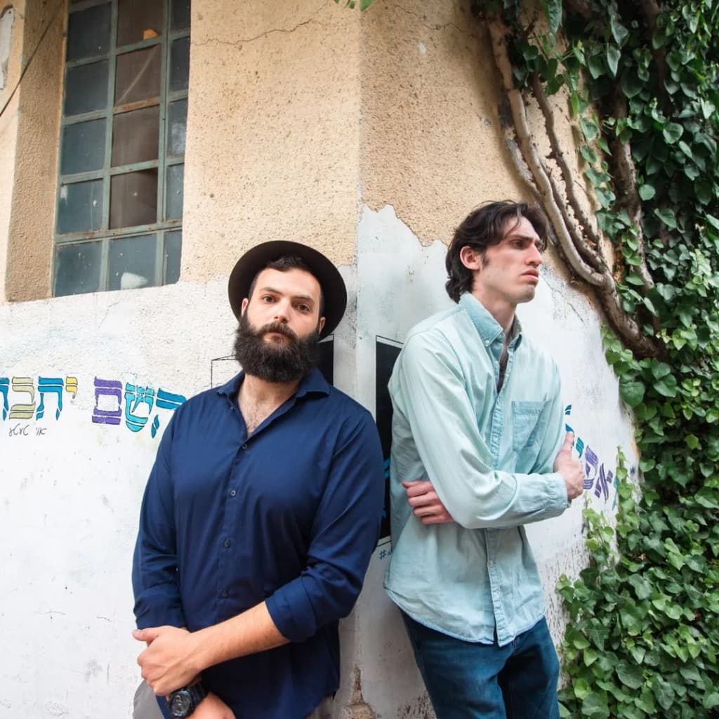 Meyer Grunberg and Isaac Simon standing at a weathered Jerusalem street corner
